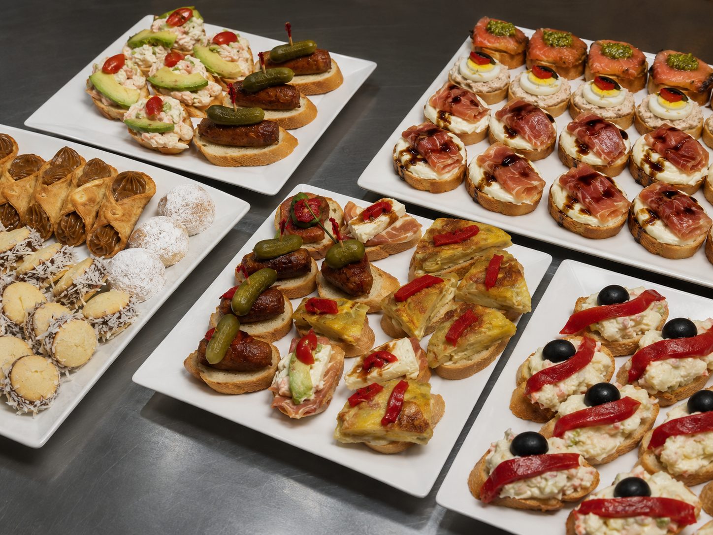 Montados and pinchos catering trays — chistorra, salmon, tortilla española, avocado and rusa