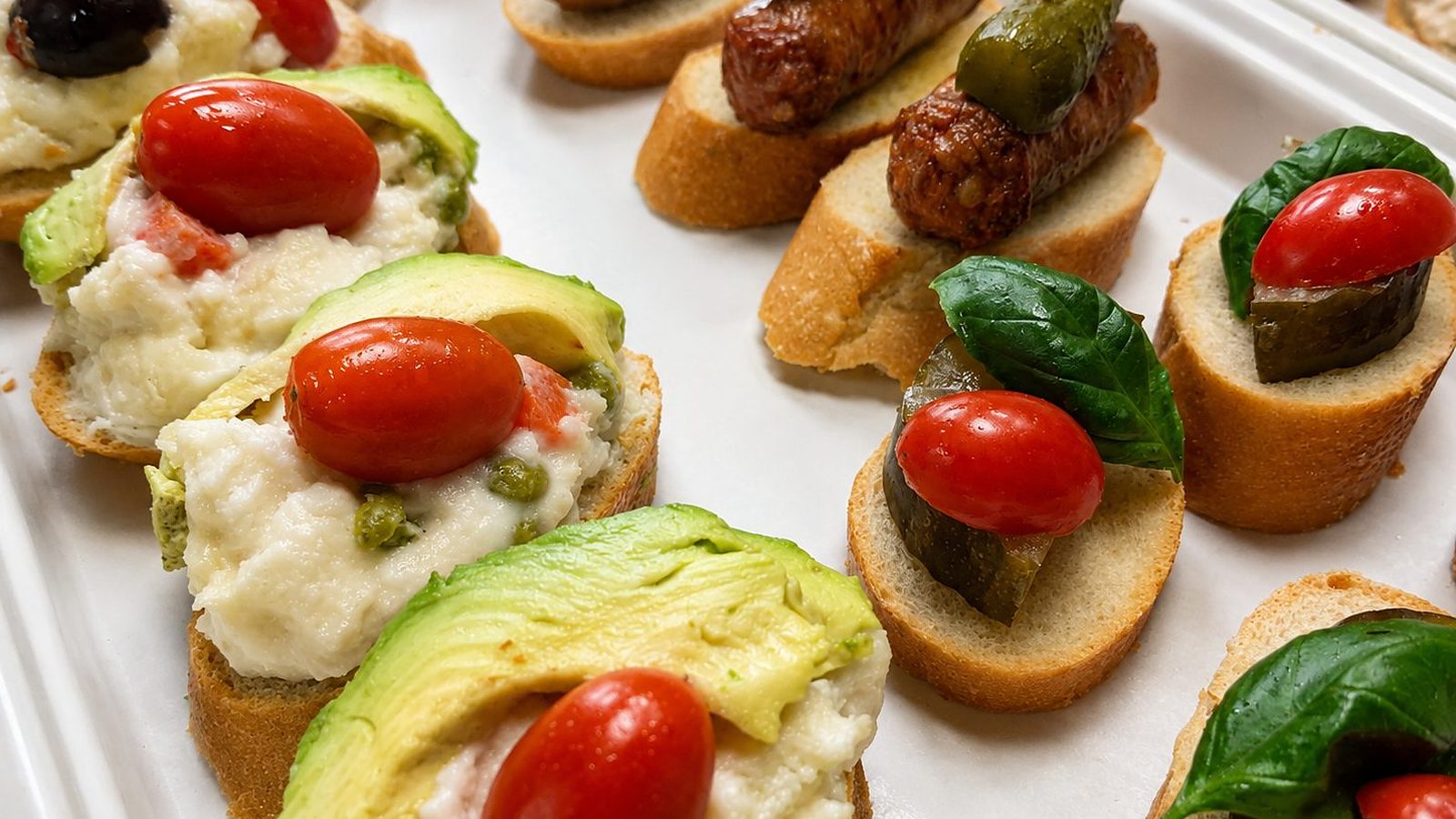 Montado tray — chistorra, ensalada rusa and avocado on toasted bread